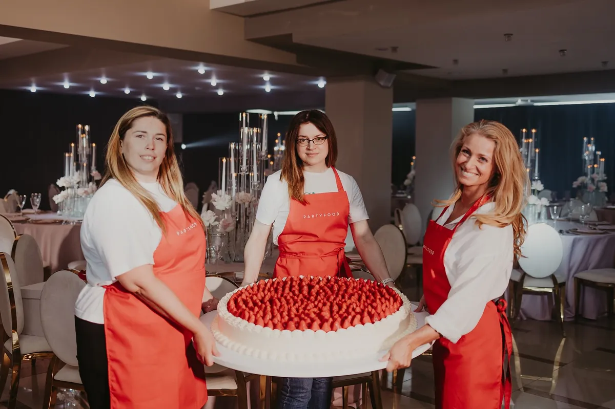 Tím PartyFood.sk s veľkou jahodovou tortou na svadobnej hostine